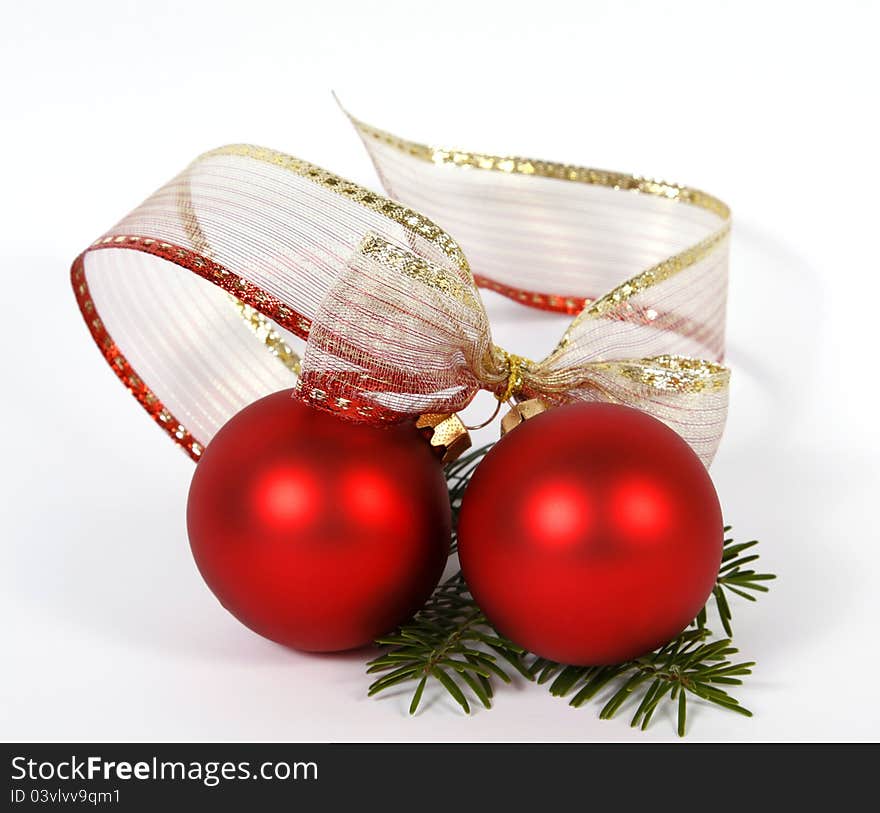 Red baubles with the ribbon on the white background. Red baubles with the ribbon on the white background