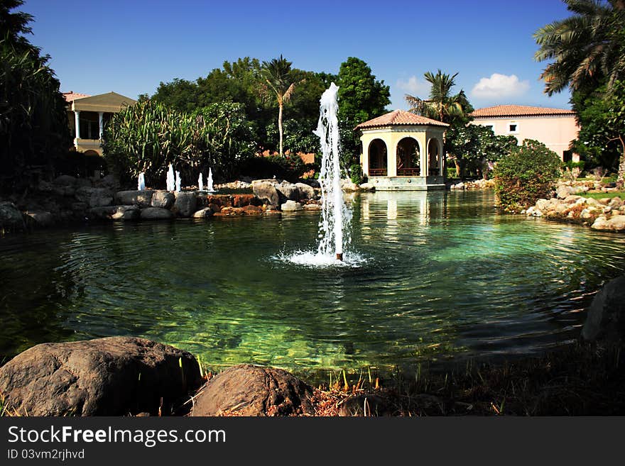 Luxury house with fountains in the garden and palm trees