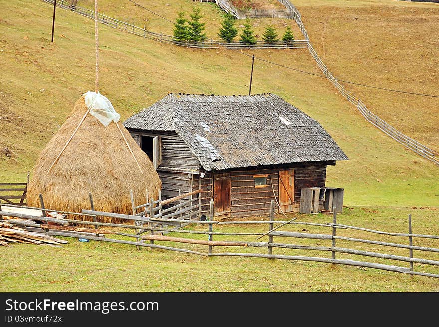 Haycock and old house in generic transylvania village. Haycock and old house in generic transylvania village