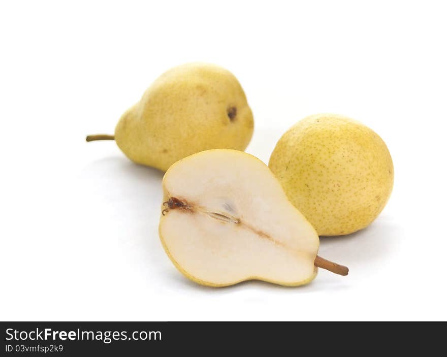 Two and a half pears on white background. Focus on front pear