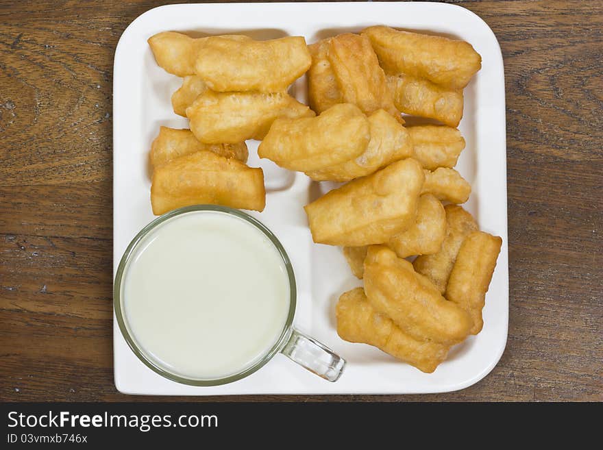 Deep fried dough sticks and a cup of soybean milk on tray