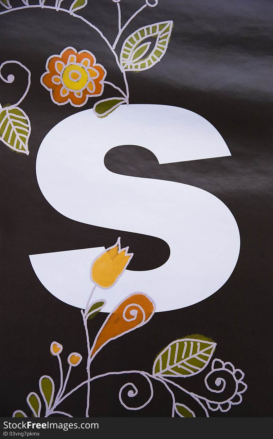 Picture of letter S decorated with hand-painted folk patterns on black background. Picture of letter S decorated with hand-painted folk patterns on black background.