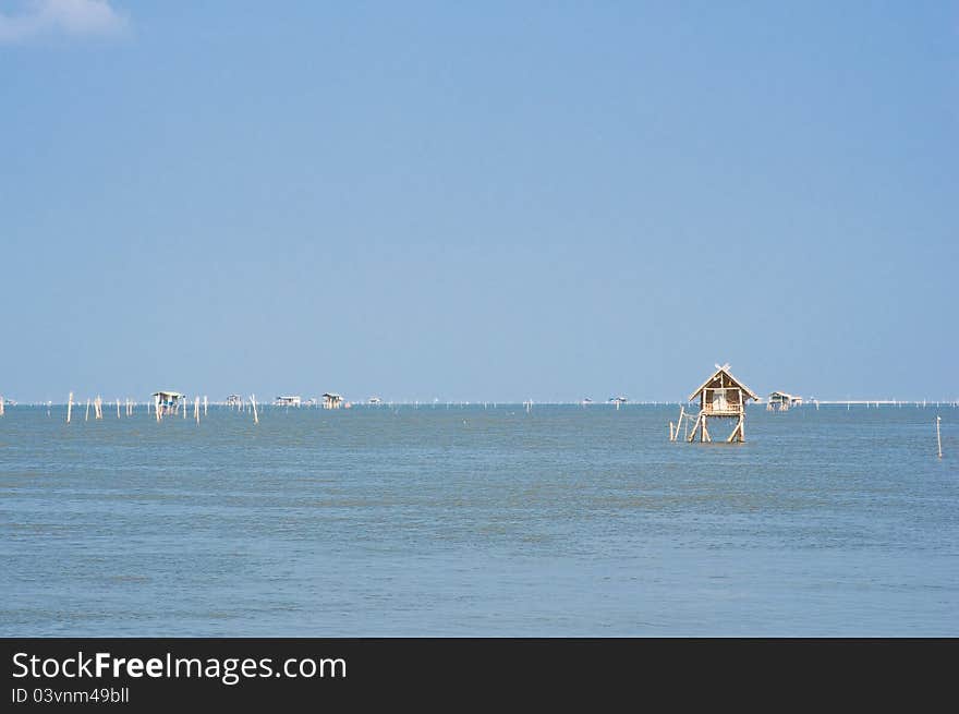 Small fisherman huts in the sea in Thailand