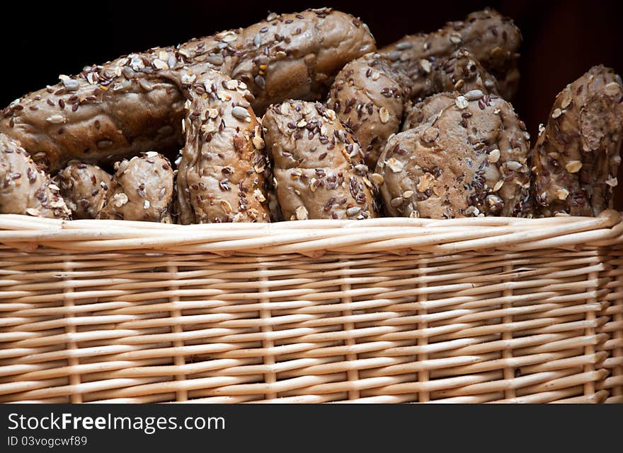 Freshly baked rustic bread rolls served in a basket. Freshly baked rustic bread rolls served in a basket.