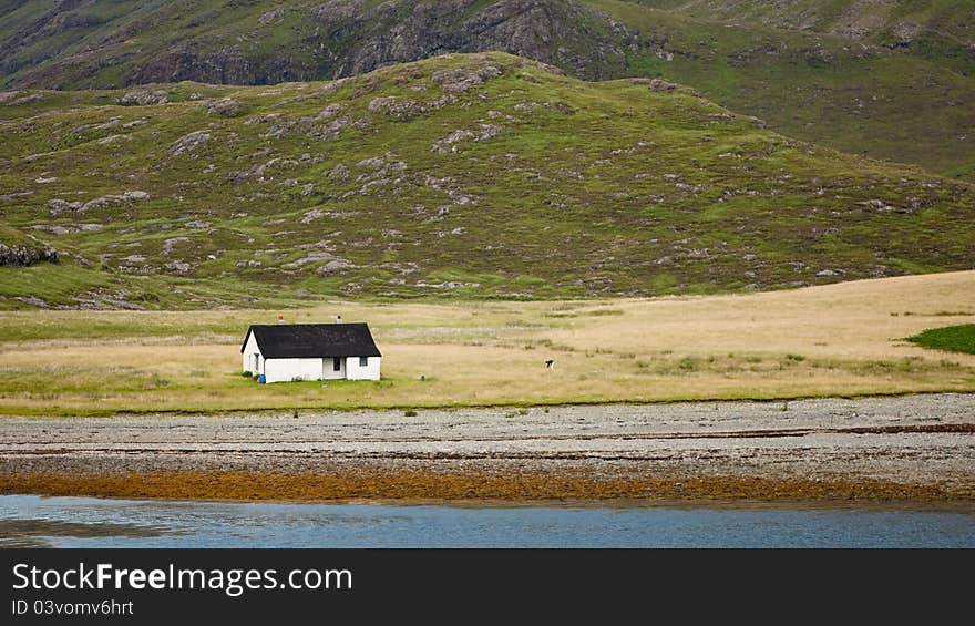 Seaside cabin in beautiful landscape under the mountains