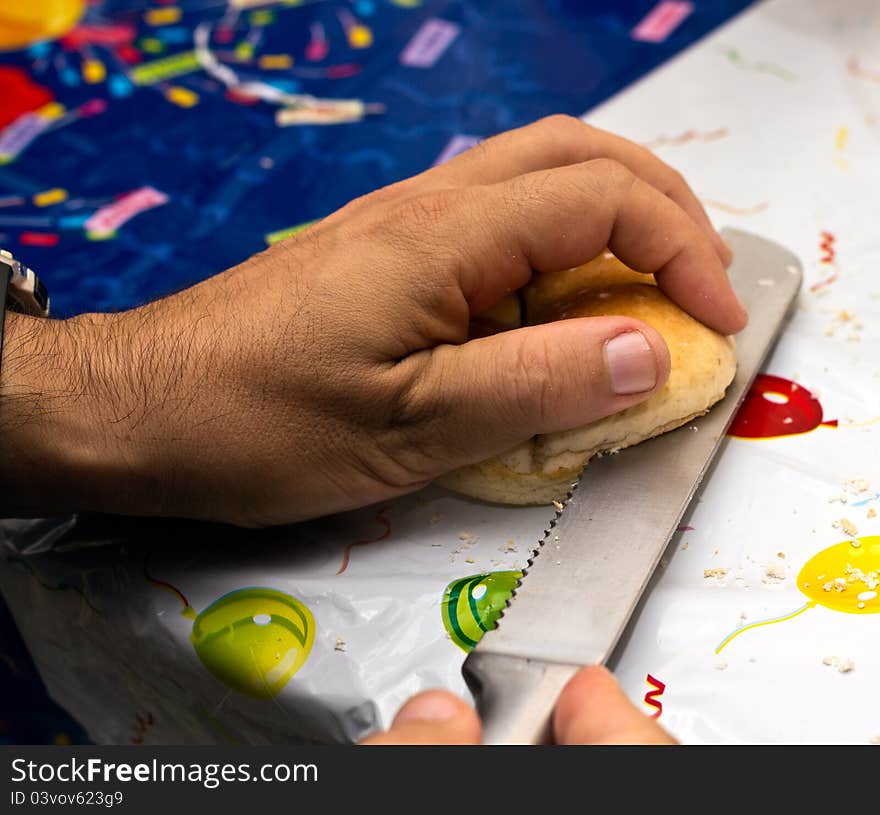 Man cutting bread for a birthday party snack