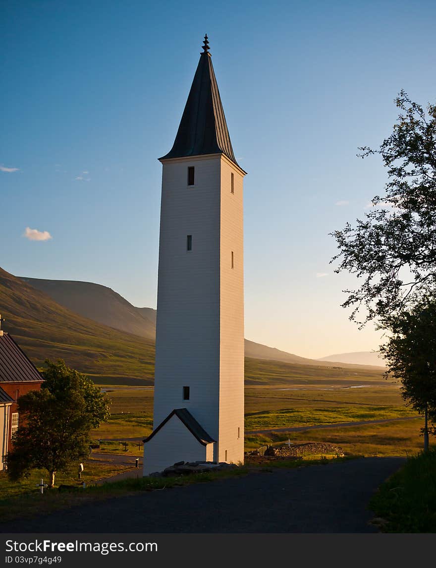 Icelandic rural church and beautiful valley in background.