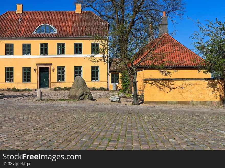 Traditional yellow Danish house on a cobbled street in Roskilde Denmark. Traditional yellow Danish house on a cobbled street in Roskilde Denmark