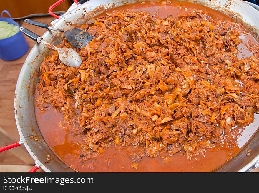 Stewed cabbage and sausages in outdoor cafe