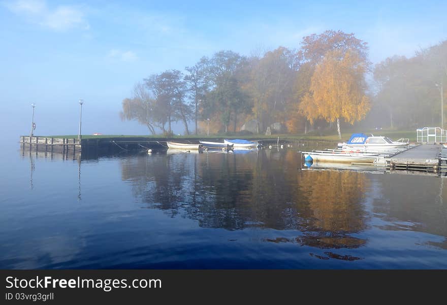 Foggy small boats harbor