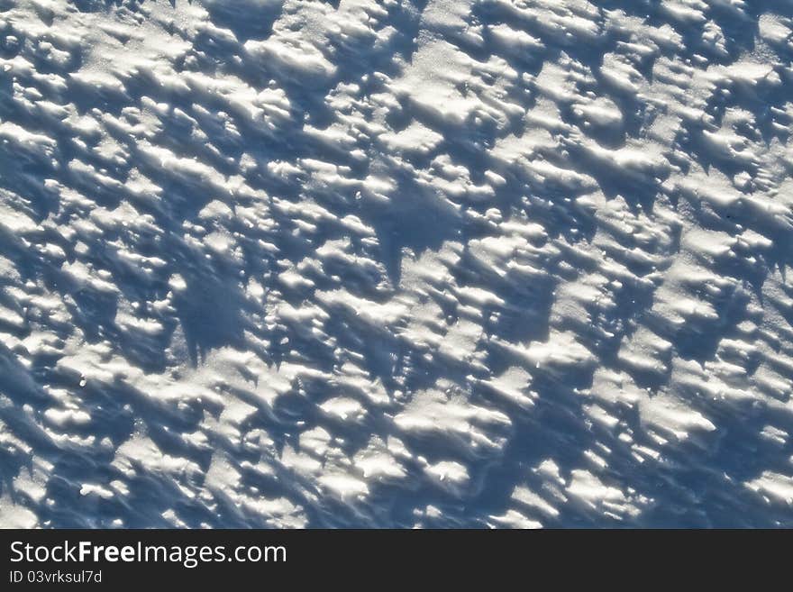 Abstract winter texture of light and shadows in snow. Abstract winter texture of light and shadows in snow