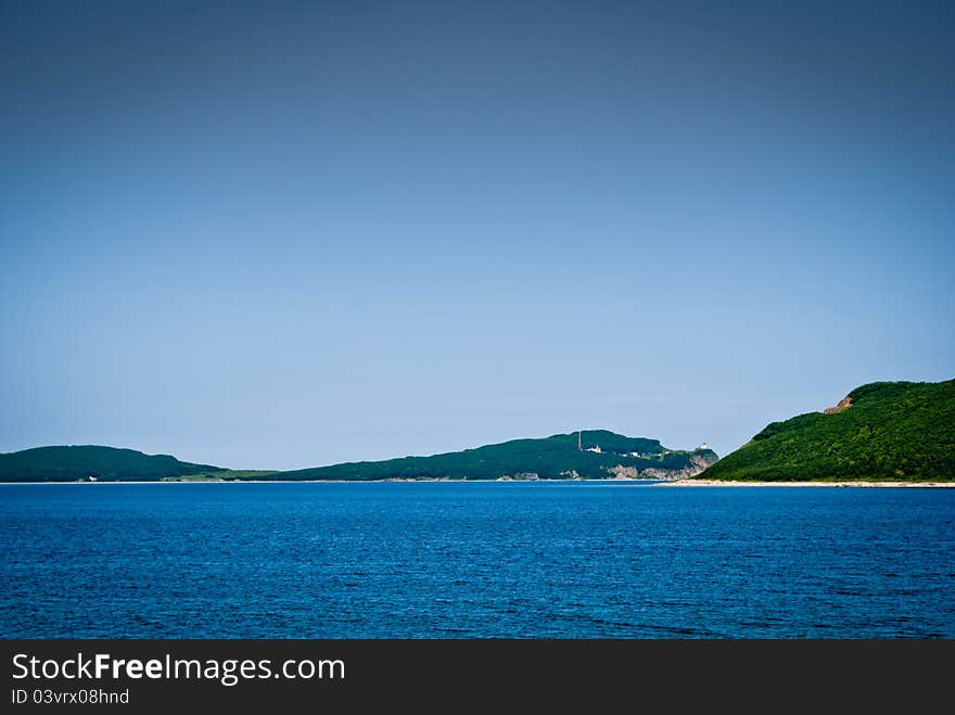 Summer see bay with blue water and hills