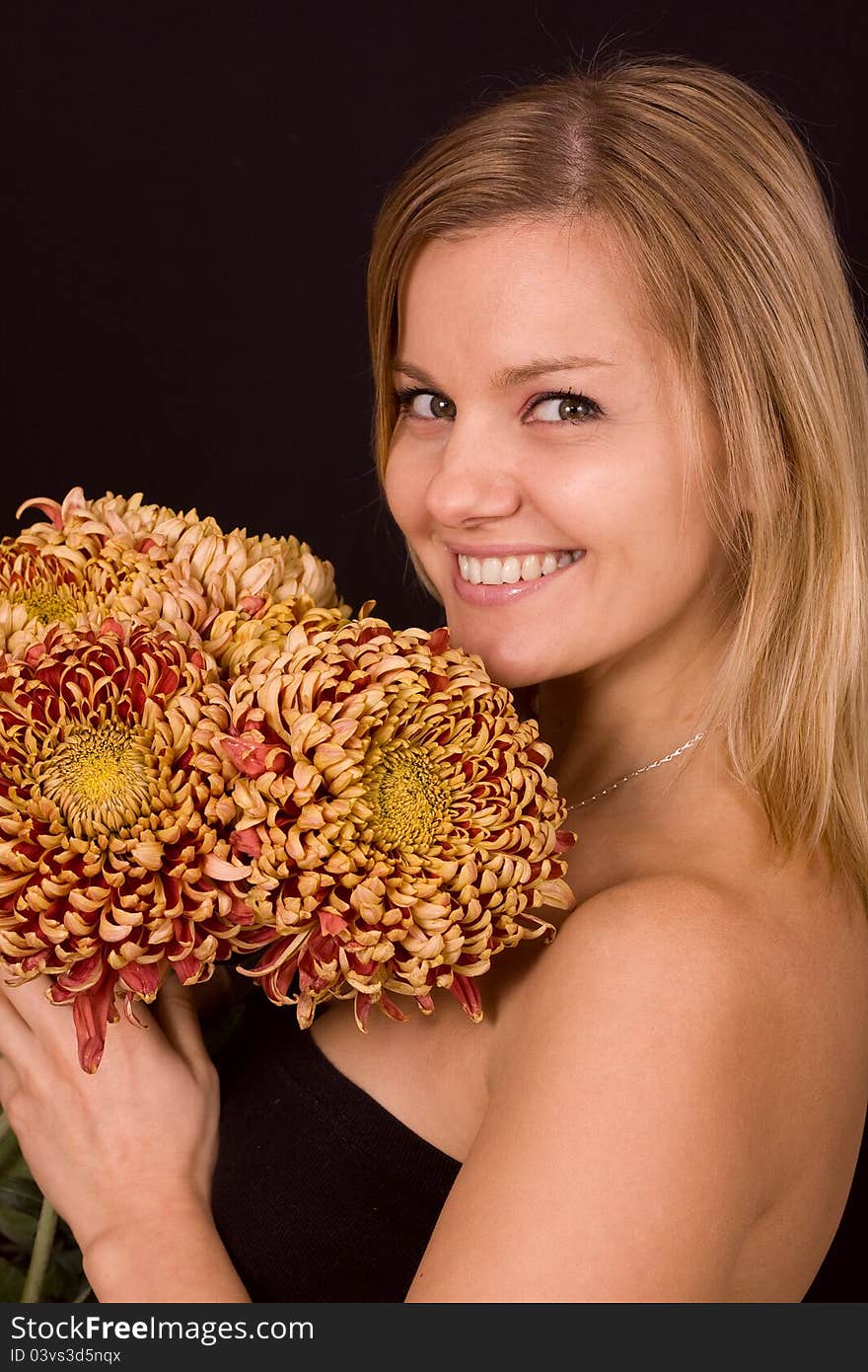 Romantic image of a young woman with yellow chrysanthemums..