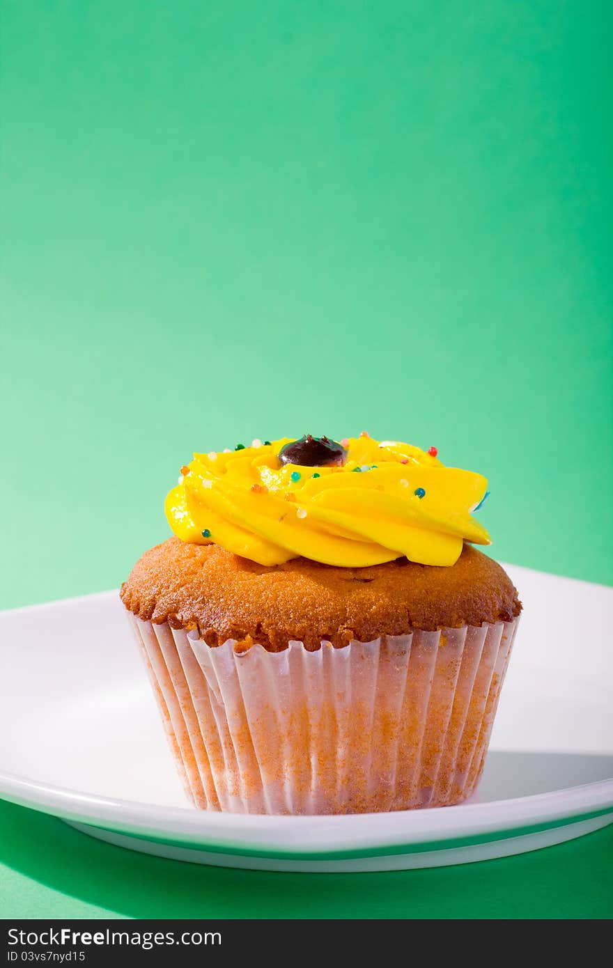 Delicious cupcake on green background.