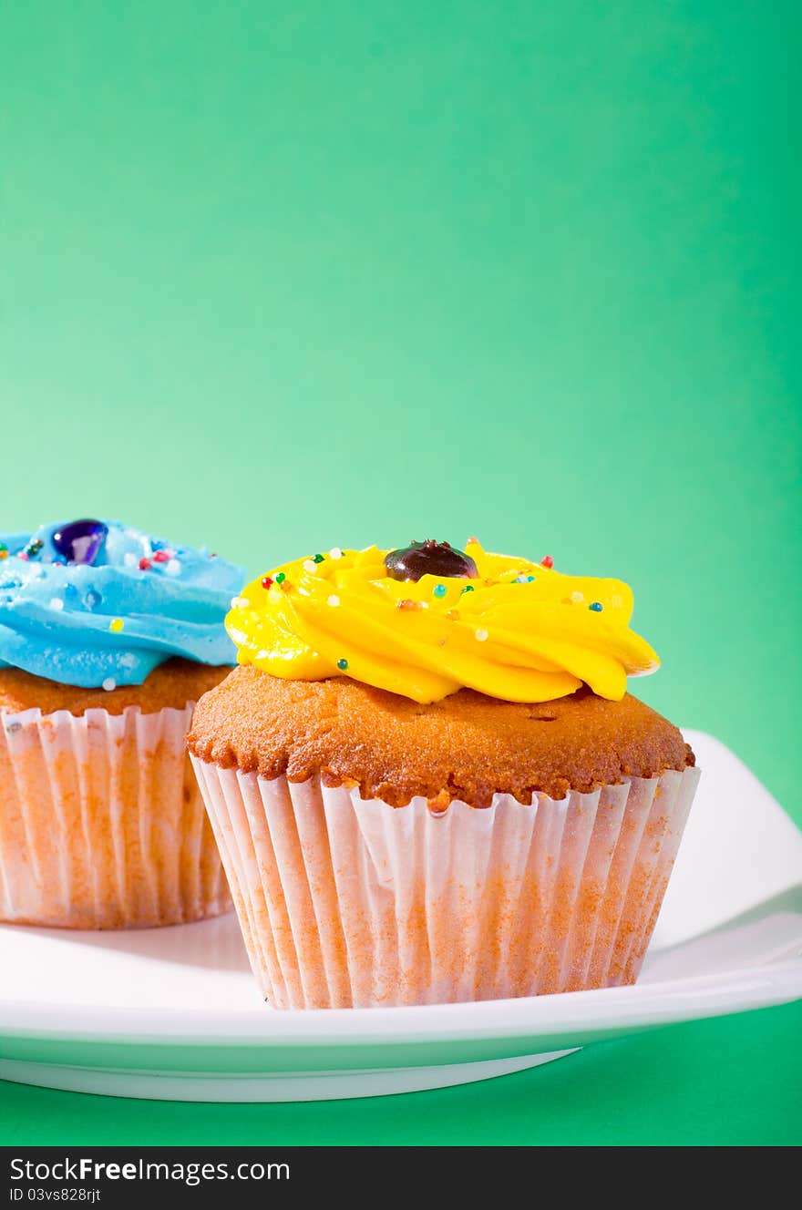 Delicious cupcake on green background.