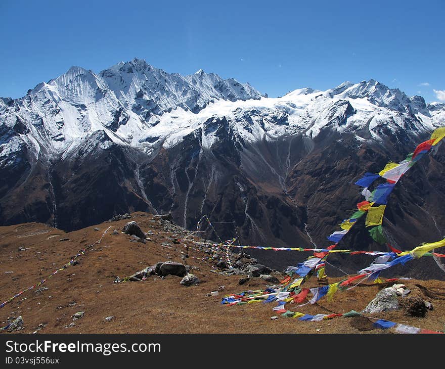 Prayer flags on a mountain-peak in the Langtang-valley, Nepal. At 4984 m. altitude.