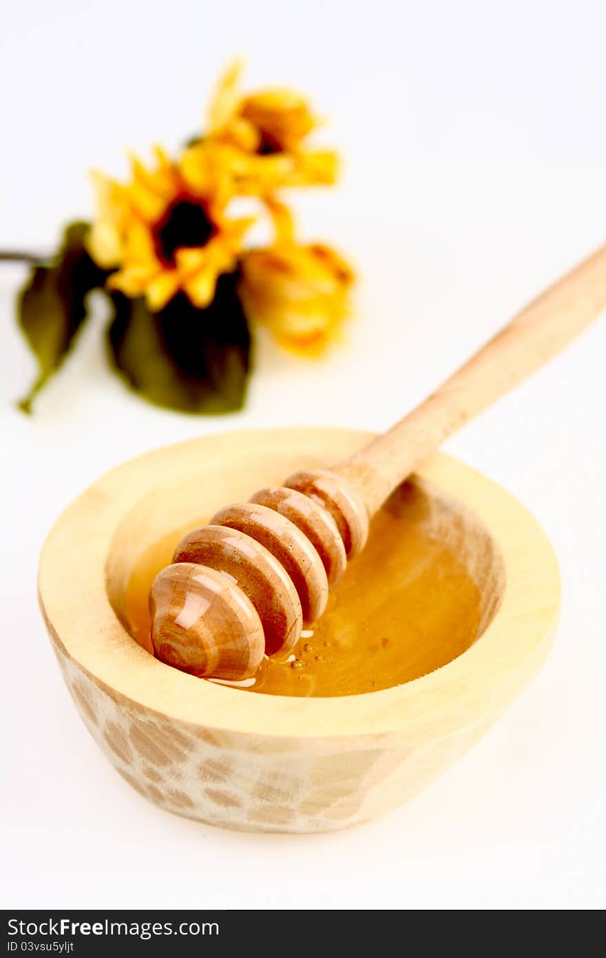 Honey in a wooden pot  on white background. Honey in a wooden pot  on white background