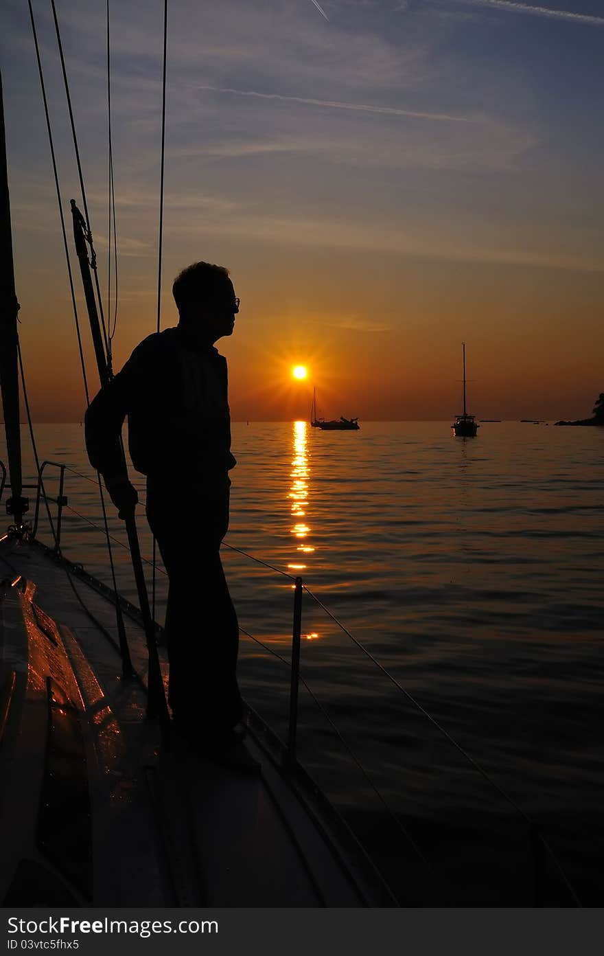 Back-lighting shape at sunset in a bay