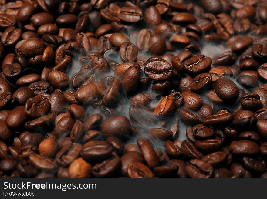 Roasted coffee beans with smoke. Roasted coffee beans with smoke