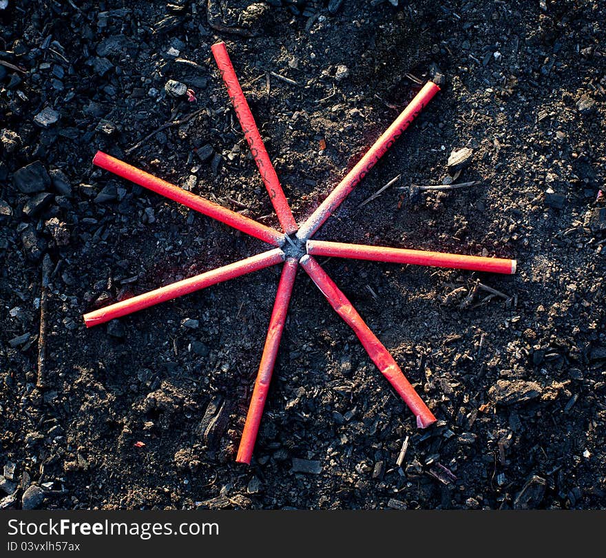 Firecrackers ready to explode, arranged in star shape on ground