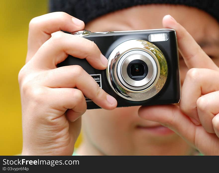 Young photographer with digital compact camera