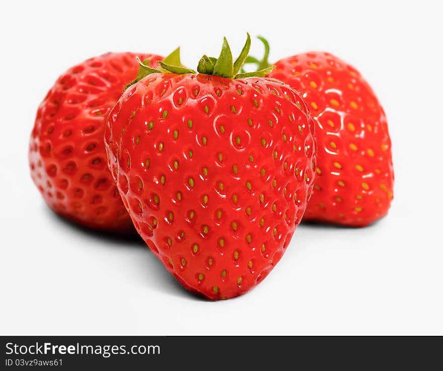 Three fresh strawberries on white background