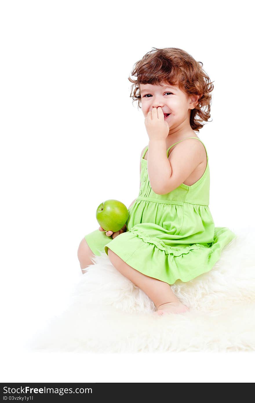 Adorable little girl eating green apple studio