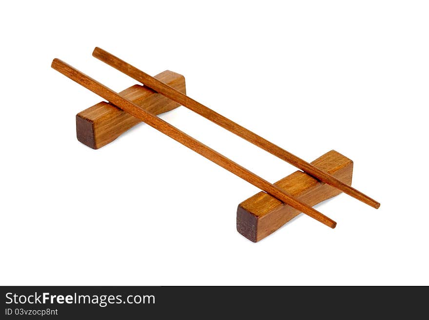 Wooden chopsticks on a stand, on a white background