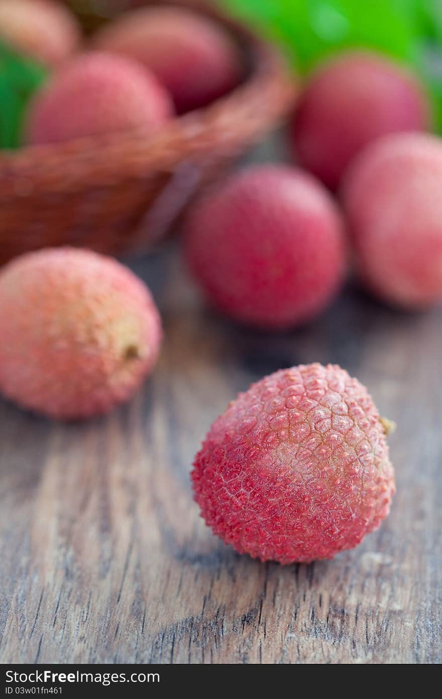 Fresh lychees fruit on wooden table, selective focus