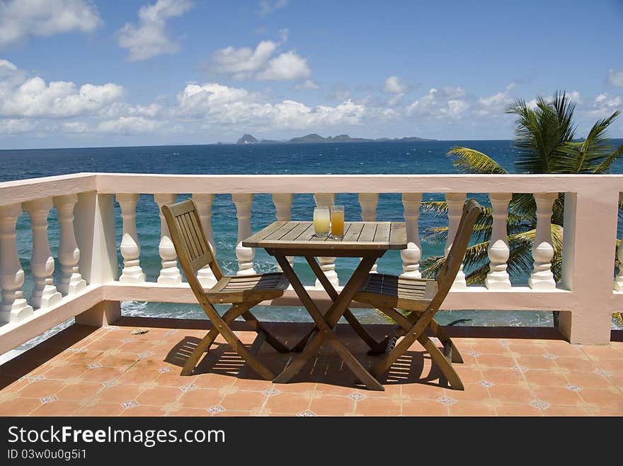 Table for two over looking the sea with island views. Table for two over looking the sea with island views.