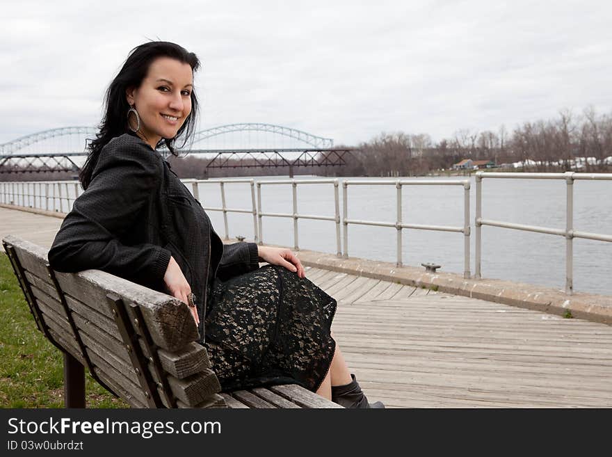 Fourty year old brunette on a bench overlooking the Connecticut river in Middletown CT. Fourty year old brunette on a bench overlooking the Connecticut river in Middletown CT