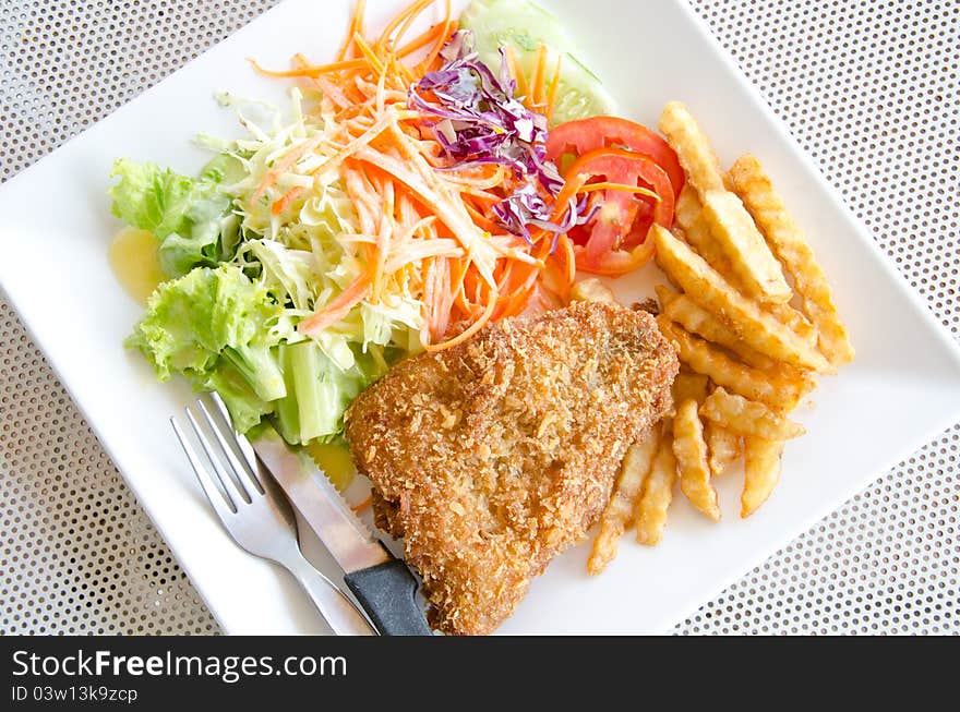 Fried fish. Served with potato and salad. Fried fish. Served with potato and salad.