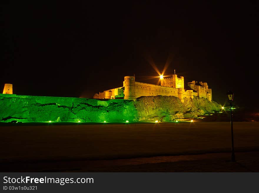 Bamburgh Castle at night with lamp post