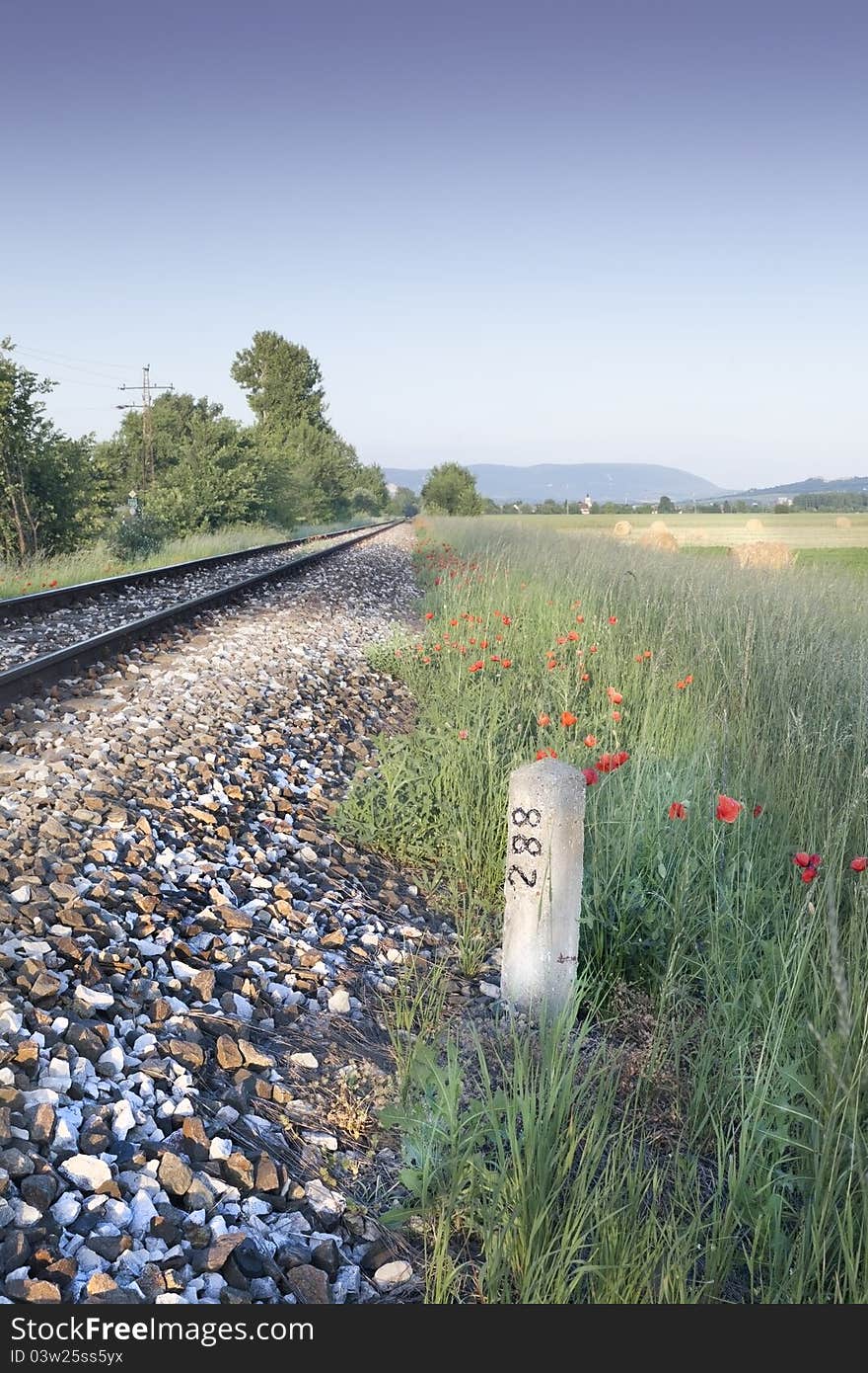 Railroad with poppies and turning post. Railroad with poppies and turning post