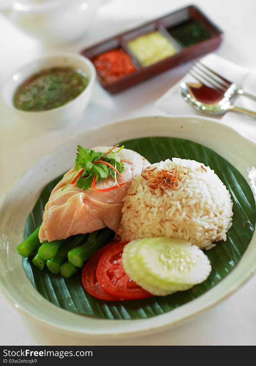 Chinese steamed chicken rice served with vegetables. Chinese steamed chicken rice served with vegetables.