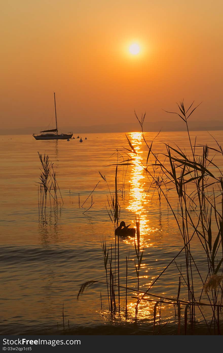 Romantic sunset silhouette of ducks and boats on Lake Garda (Italy). Romantic sunset silhouette of ducks and boats on Lake Garda (Italy)