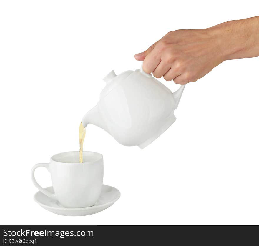 Teapot pouring tea into a cup on a white background