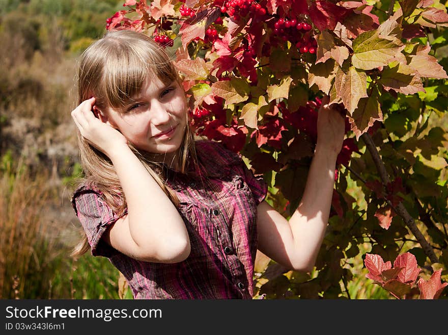 Girl near the ashberry bush shrub