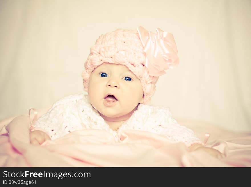 Cute baby girl in a pink hat