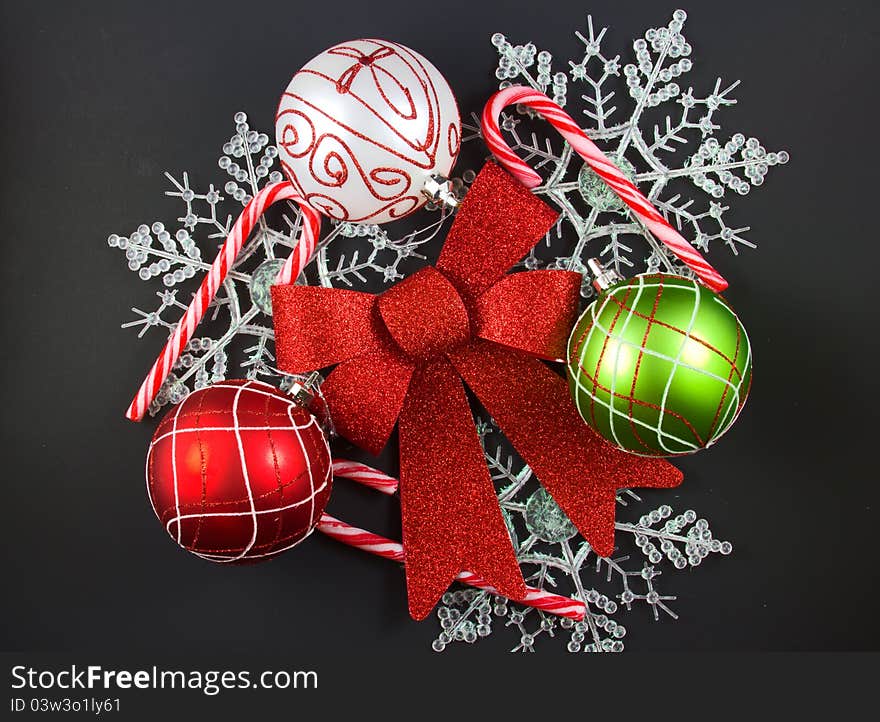 Christmas decorations of colorful ornaments, candy cane, ribbon and snowflakes.