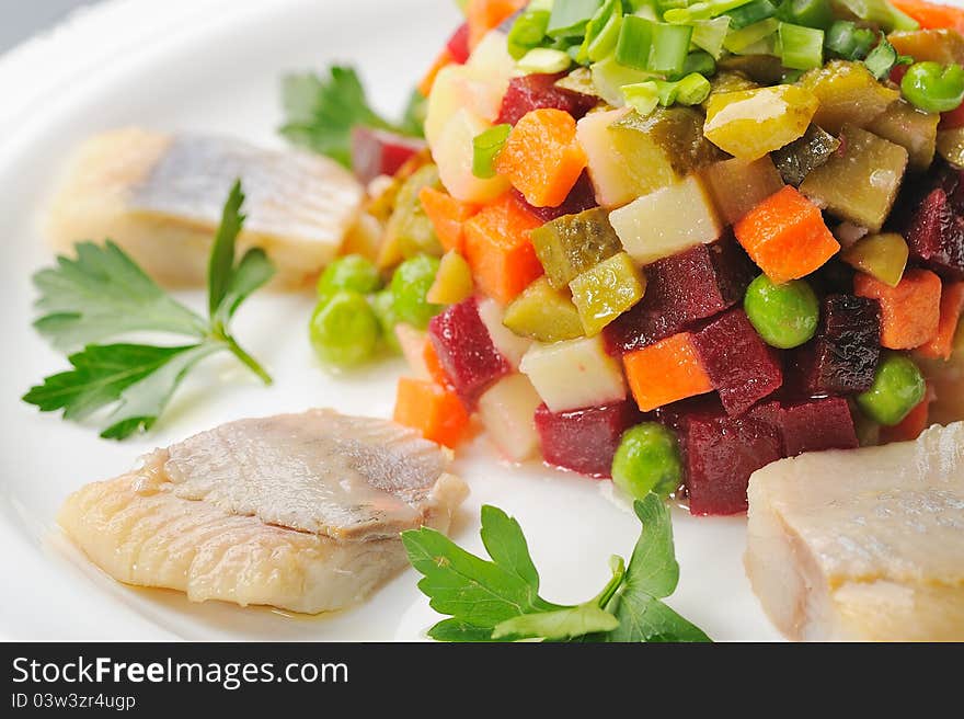 Chopped boiled vegetables with herring on plate. Chopped boiled vegetables with herring on plate