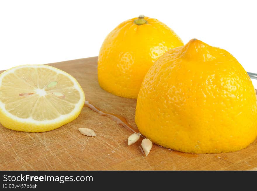 Cut Lemon With Seeds On Wooden Cutting Board