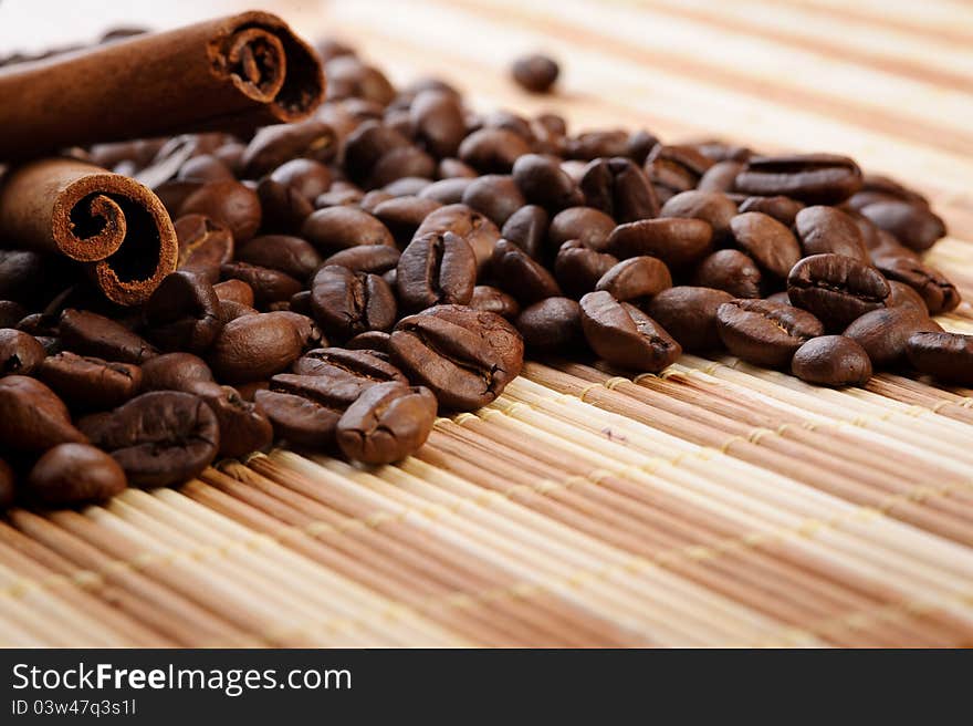 Handful aromatic coffee beans with cinnamon