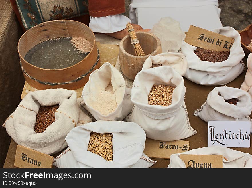 Reproduction of old grain store whit assortment of cereals, legumes and flour - wheat, oats, barley, spelt, ingredients of mediterranean diet