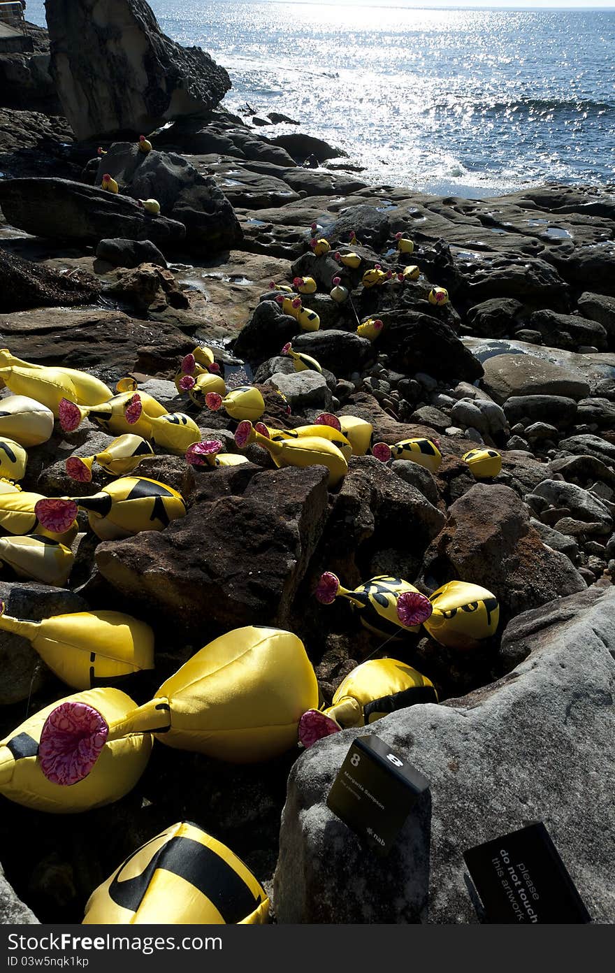 Yellow things Sculpture at Sculptures by the Sea Bondi Beach with One of the Scultures featured in the Sculptures by the Sea Bondi Beach Sydney. Annual Sculptures by the Sea exhibition, Sydney, Australia during November. Copyspace. Yellow things Sculpture at Sculptures by the Sea Bondi Beach with One of the Scultures featured in the Sculptures by the Sea Bondi Beach Sydney. Annual Sculptures by the Sea exhibition, Sydney, Australia during November. Copyspace.