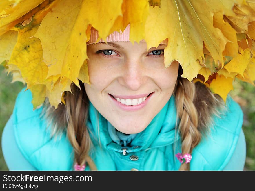 Young woman in autumn leaves