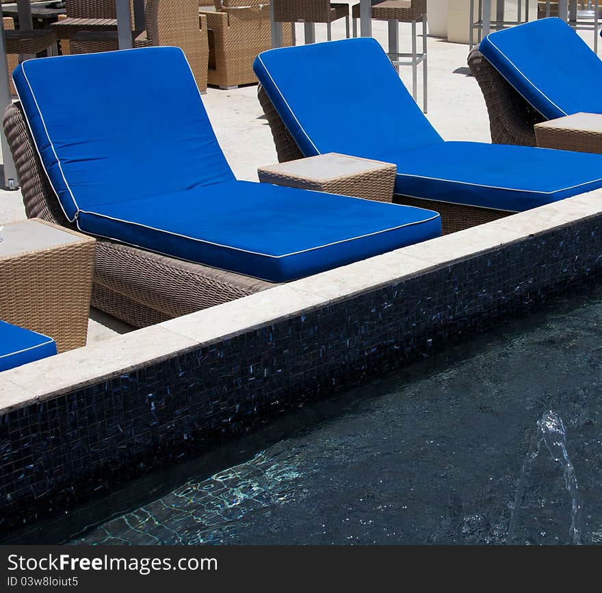 Blue lounge chairs beside wading pool