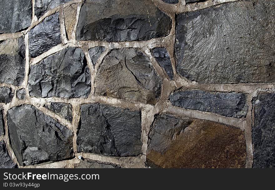 Urban wall with stone shapes in exterior scene. Urban wall with stone shapes in exterior scene