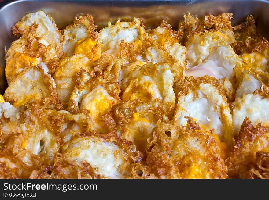 Crispy fried egg. Which is arranged in rows on the tray.