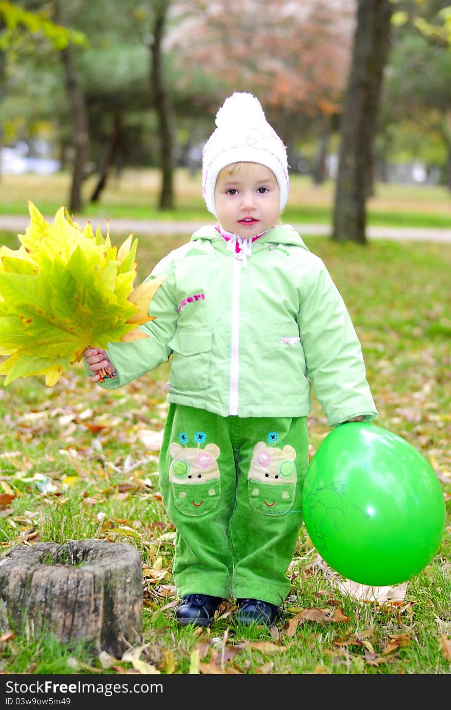 Small beautiful girl in green suit